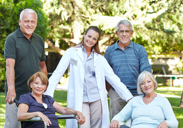 group of elderly people and caregiver