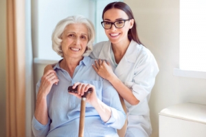 caregiver wearing glasses with an elderly woman
